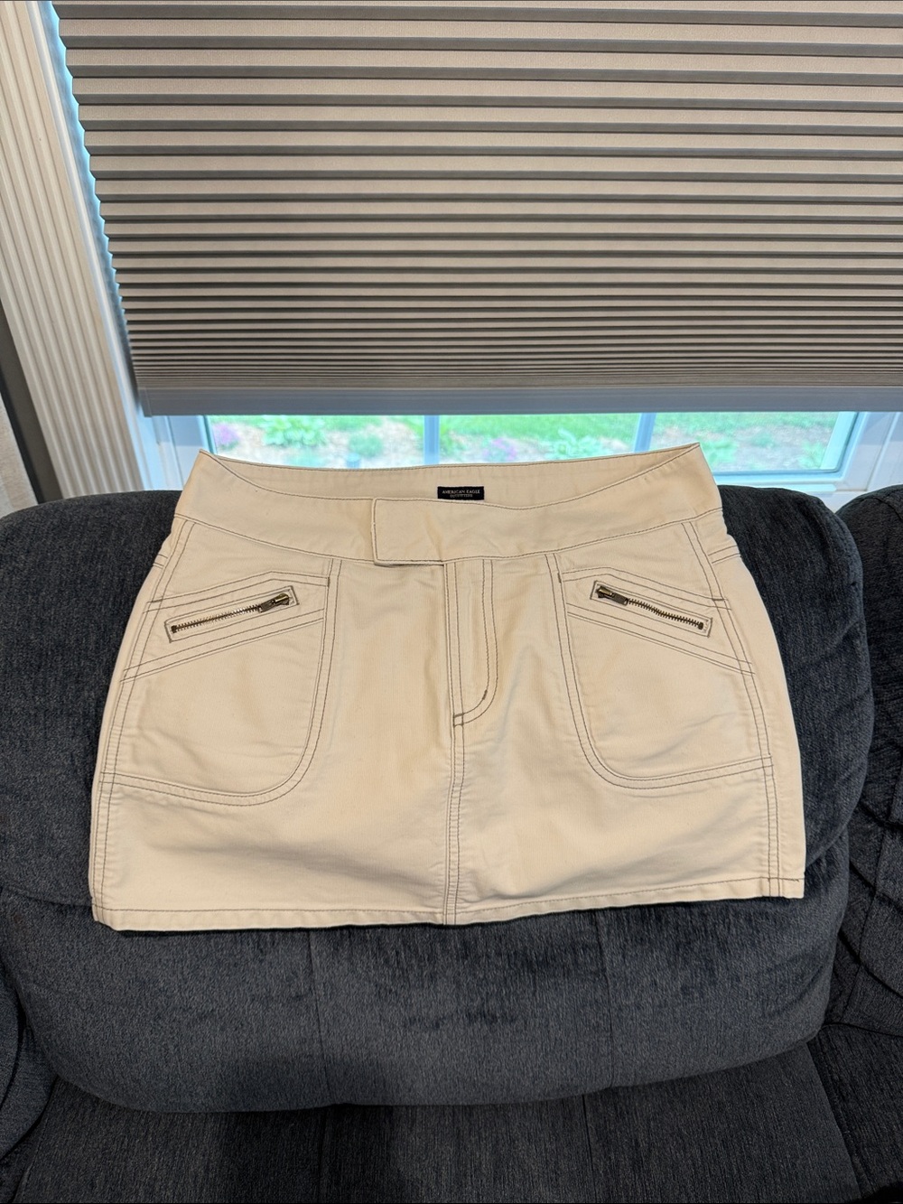Express Cream Mini Skirt with Front Zip Pockets
